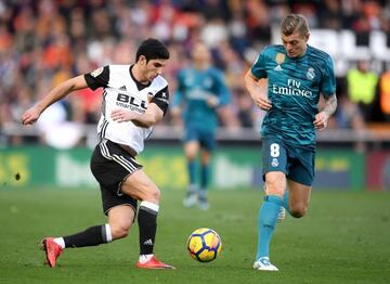 Goncalo Guedes of Valencia and Toni Kroos of Real Madrid battle for the ball during the La Liga match.