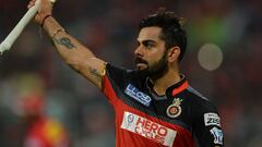 Royal Challengers Bangalore captain and batsman Virat Kohli gestures to the cheering crowd as he walks back to the pavilion after being dismissed for 113 runs during the 2016 Indian Premier League (IPL) Twenty20 cricket match between Royal Challengers Ban
