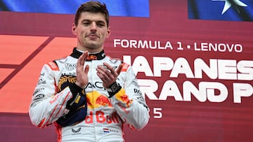 Winner Red Bull Racing's Dutch driver Max Verstappen applauds on the podium after the Formula One Japanese Grand Prix at the Suzuka circuit in Suzuka, Mie prefecture, Japan on April 6, 2025. (Photo by Toshifumi KITAMURA / AFP)