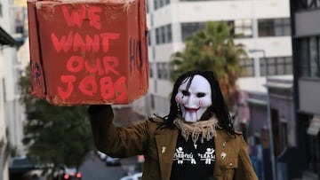 A worker of the hospitality industry carries a mock coffin outside a closed bar during a protest against the coronavirus disease (COVID-19) lockdown regulations and job losses in Cape Town, South Africa, August 6, 2020. REUTERS/Mike Hutchings