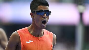 Spain's Mohamed Attaoui reacts after competing in the men's 800m heat of the athletics event at the Paris 2024 Olympic Games at Stade de France in Saint-Denis, north of Paris, on August 7, 2024. (Photo by Jewel SAMAD / AFP)