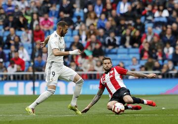 El jugador del Real Madrid Benzema trata de controlar el balón ante el jugador del Athletic Club Íñigo Martínez.