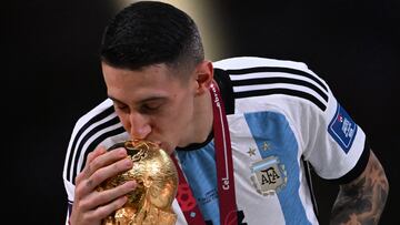 Argentina's midfielder #11 Angel Di Maria kisses the FIFA World Cup Trophy during the trophy ceremony after Argentina won the Qatar 2022 World Cup final football match between Argentina and France at Lusail Stadium in Lusail, north of Doha on December 18, 2022. (Photo by Kirill KUDRYAVTSEV / AFP)