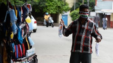 A vendor wearing a facemask printed with the India national flag attracts customers for Indian Independence Day in Hyderabad.