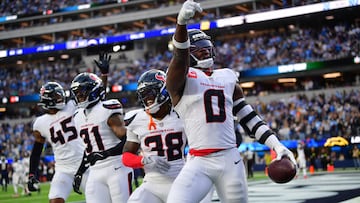 Dec 27, 2025; Inglewood, California, USA; Houston Texans linebacker Azeez al-Shaair (0) reacts with safety K'Von Wallace (38) after making an interception against the Los Angeles Chargers during the first half at SoFi Stadium. Mandatory Credit: Gary A. Vasquez-Imagn Images
