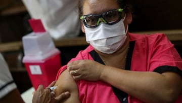 A medical worker gets vaccinated with the second dose of the Sputnik V (Gam-COVID-Vac) vaccine at the San Martin hospital, in La Plata, on the outskirts of Buenos Aires, Argentina January 21, 2021. REUTERS/Agustin Marcarian