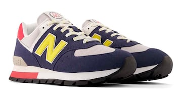 New Balance 574para hombre en azul, amarillo y rojo.