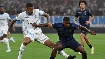 Marseille's English forward #10 Mason Greenwood and Reims' French midfielder #10 Teddy Teuma fight for the ball during the French L1 football match between Olympique Marseille (OM) and Stade de Reim at Stade Velodrome in Marseille, southern France on August 25, 2024. (Photo by Miguel MEDINA / AFP)