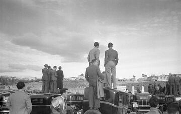 Seguidores subidos a las farolas y los taxis estacionados para ver el partido en el Estadio Metropolitano, 1947.