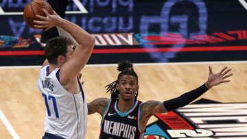 May 11, 2021; Memphis, Tennessee, USA; Memphis Grizzlies guard Ja Morant (12) defends Dallas Mavericks guard Luka Doncic (77) during the first quarter at FedExForum. Mandatory Credit: Petre Thomas-USA TODAY Sports