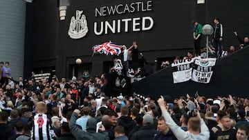 Newcastle United supporters celebrate outside St James' Park after the sale of the football club to a Saudi-led consortium was confirmed in 2021.
