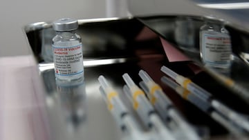 FILE PHOTO: A vial containing doses of the Moderna vaccine against the coronavirus disease (COVID-19) and syringes are pictured at Japan Airlines (JAL) facility where its staff receive the vaccines at Haneda airport in Tokyo, Japan June 14, 2021. REUTERS/Kim Kyung-Hoon/File Photo