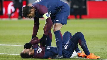 Paris Saint-Germain's Brazilian defender Thiago Silva (up) speaks to Paris Saint-Germain's Brazilian forward Neymar Jr lying on the pitch during the French L1 football match between Paris Saint-Germain (PSG) and Marseille (OM) at the Parc des Pr