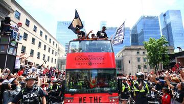 TORONTO, ON - JUNE 17: Malcolm Miller #13, Jodie Meeks #20 and Serge Ibaka #9 of the Toronto Raptors look on from their bus during the Toronto Raptors Victory Parade on June 17, 2019 in Toronto, Canada. The Toronto Raptors beat the Golden State Warriors 4