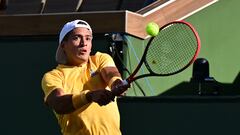 Sebastian Baez of Argentina hits a backhand return to Taylor Fritz of the US in their third round match at the 2023 WTA Indian Wells Open in Indian Wells, California, on March 13, 2023. (Photo by Frederic J. BROWN / AFP)