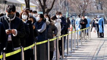 People wait in line to undergo the coronavirus disease (COVID-19) test at a temporary testing site set up at City Hall Plaza in Seoul, South Korea, February 10, 2022.  REUTERS/ Heo Ran