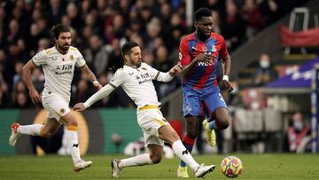 06 November 2021, United Kingdom, London: Crystal Palace&#039;s Odsonne Edouard is tackled by Wolverhampton Wanderers&#039; Joao Moutinho during   the English Premier League soccer match between Crystal Palace and Wolverhampton Wanderers at Selhurst Park 