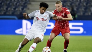 Karim Adeyemi (L) and Sevilla's Swedish defender Ludwig Augustinsson vie for the ball during the UEFA Champions League Group G football match RB Salzburg v Sevilla.