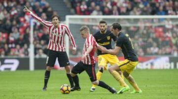 Muniain con el balón se va de Godín.