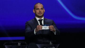 Former Dutch international Wesley Sneijder holds the slip of Valencia FC during the UEFA Champions League football group stage draw ceremony in Monaco on August 29, 2019. (Photo by Valery HACHE / AFP)