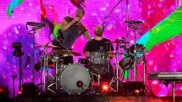 British singer Chris Martin (L) and drummer Will Champion (R) of British band Coldplay perform on the main stage during Rock in Rio music festival at Rio 2016 Olympic Park in Rio de Janeiro, Brazil, on September 11, 2022. (Photo by MAURO PIMENTEL / AFP) (Photo by MAURO PIMENTEL/AFP via Getty Images)