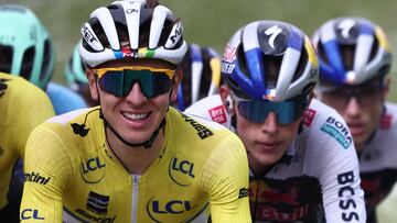 UAE Team Emirates XRG's Slovenian rider Tadej Poga?ar wearing the overall leader's yellow jersey (L) cycles during the 8th and final stage of the 77th edition of the Criterium du Dauphine cycling race, 133,3 km between Val-d'Arc and Val-Cenis - Plateau du Mont Cenis, on June 15, 2025. (Photo by Anne-Christine POUJOULAT / AFP)
