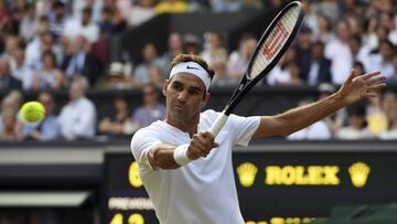 El tenista suizo Roger Federer devuelve la pelota ante el b&uacute;lgaro Grigor Dimitrov durante su encuentro de cuarta ronda del torneo de Wimbledon.