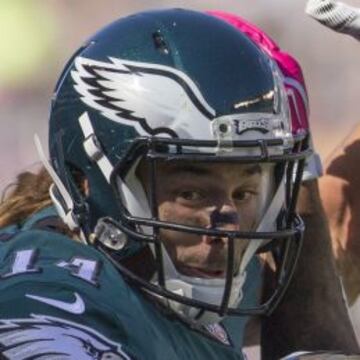 Riley Cooper no consigue atrapar el balón, pero agarra firmemente el casco de Brandon Browner.