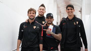 Banega señala al Mudo Vázquez, con Ocampos y Bono saliendo ayer destino a Madrid.
