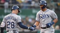 OAKLAND, CA - MAY 30: Carlos Gomez #27 of the Tampa Bay Rays is congratulated by Daniel Robertson #28 after Gomez scored against the Oakland Athletics in the top of the second inning at the Oakland Alameda Coliseum on May 30, 2018 in Oakland, California. 