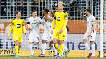 Augsburg&#039;s German midfielder Joel Noah Sarenren Bazee (C) celebrates scoring the equalising goal 1:1 with his team mates during the German first division Bundesliga football match between FC Augsburg and Borussia Dortmund in Augsburg, southern German