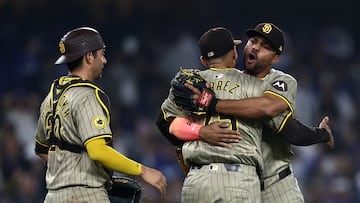 LOS ANGELES, CALIFORNIA - SEPTEMBER 24: Kyle Higashioka #20, Robert Suarez #75 and Xander Bogaerts #2 of the San Diego Padres celebrate after the 4-2 win against the Los Angeles Dodgers to clinch a playoff spot at Dodger Stadium on September 24, 2024 in Los Angeles, California. Katelyn Mulcahy/Getty Images/AFP (Photo by Katelyn Mulcahy / GETTY IMAGES NORTH AMERICA / Getty Images via AFP)