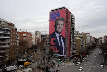 TOPSHOT - A giant electoral poster of candidate for presidency of FC Barcelona Joan Laporta is displayed on a building next to the Santiago Bernabeu Stadium in Madrid on December 16, 2020. - Barcelona will hold elections for a new president on January 24,