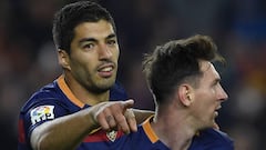 Luis Suarez celebrates with Lionel Messi 