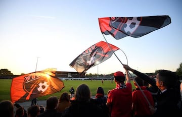 Supporters of the French third division (National 1) football club Les Herbiers cheer their team during a French National 1 football match between Les Herbiers and Laval at the Massabielle stadium in Les Herbiers on May 4, 2018.