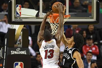 Brooklyn Nets' Jarrett Allen (R) tries to stop Miami Heat's Bam Adebayo from dunking the ball, during an NBA Global Games match at the Mexico City Arena, on December 9, 2017, in Mexico City. / AFP PHOTO / PEDRO PARDO