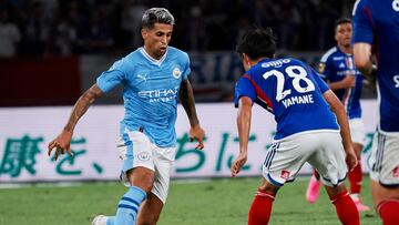 Manchester City�s defender Joao Cancelo (L) dribbles the ball in front of Yokohama�s midfielder Riku Yamane during the J-League World Challenge 2023 football match between English Premier League champion Manchester City and Yokohama F-Marinos at the National Stadium in Tokyo on July 23, 2023. (Photo by Toshifumi KITAMURA / AFP)