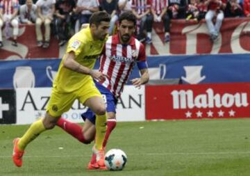 El centrocampista del Villarreal Cani (i) disputa un balón con el centrocampista del Atlético de Madrid Raúl García (d).