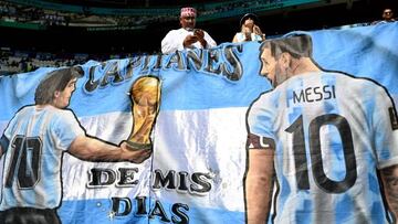 Supporters wave a banner depicting football legend Diego Maradona (L) and Argentina's forward #10 Lionel Messi before the start of the Qatar 2022 World Cup Group C football match between Argentina and Saudi Arabia at the Lusail Stadium in Lusail, north of Doha on November 22, 2022. (Photo by Kirill KUDRYAVTSEV / AFP) (Photo by KIRILL KUDRYAVTSEV/AFP via Getty Images)