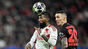 Olympiakos' Brazilian defender #23 Rodinei (L) and Bayer Leverkusen's Spanish defender #20 Alejandro Grimaldo vie for the ball during the UEFA Champions League play-off, second-Leg football match Bayer 04 Leverkusen vs Olympiakos in Leverkusen, western Germany, on February 24, 2026. (Photo by INA FASSBENDER / AFP)