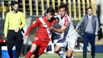 LEON, SPAIN - JANUARY 28:  Angel Garcia of Cultural Leonesa duels for the ball with Marc Gual of Sevilla II during La Liga 2 play off round between Cultural Leonesa and Sevilla II at Reino de Leon Stadium on January 28, 2018 in Leon, Spain.  (Photo by Jua