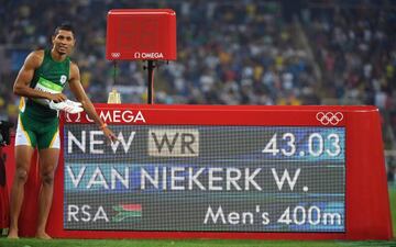 South Africa's Wayde van Niekerk poses by the results board after he broke the world record in the Men's 400m Final.