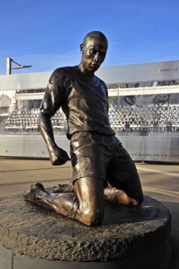 A statue of Henry stands outside Arsenal's Emirates Stadium.