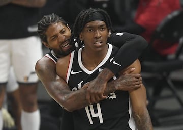 Paul George #13 of the Los Angeles Clippers hugs Terance Mann #14 of the Los Angeles Clippers after he scored a basket against Utah Jazz during the first half in Game Six of the Western Conference second-round playoff series at Staples Center on June 18, 