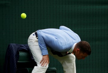 FILE PHOTO: Tennis - Wimbledon - All England Lawn Tennis and Croquet Club, London, Britain - July 9, 2018  A line judge dodges a tennis ball during the fourth round match between South Africa's Kevin Anderson and France's Gael Monfils    REUTERS/Andrew Boyers/File Photo