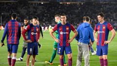 Barcelona's Spanish midfielder #08 Pedri, Barcelona's Spanish forward #07 Ferran Torres and Barcelona's Polish forward #09 Robert Lewandowski react at the end of the UEFA Champions League quarter-final second leg football match between FC Barcelona and Paris SG at the Estadi Olimpic Lluis Companys in Barcelona on April 16, 2024. (Photo by Josep LAGO / AFP)