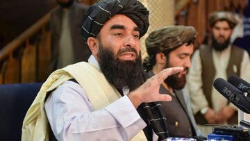 Taliban spokesperson Zabihullah Mujahid (L) gestures as he speaks during the first press conference in Kabul on August 17, 2021 following the Taliban stunning takeover of Afghanistan. (Photo by Hoshang Hashimi / AFP)