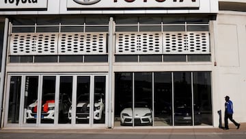 FILE PHOTO: A man walks past a closed Toyota car dealership during the coronavirus disease (COVID-19) nationwide lockdown in Cape Town, South Africa, April 28, 2020.   REUTERS/Mike Hutchings/File Photo  GLOBAL BUSINESS WEEK AHEAD