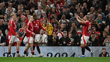 Manchester United's English striker #10 Marcus Rashford (C) celebrates scoring the opening goal with Manchester United's Argentinian midfielder #17 Alejandro Garnacho (2L) and and Manchester United's Danish midfielder #14 Christian Eriksen (R) during the English League Cup third round football match between Manchester United and Barnsley at Old Trafford in Manchester, north west England, on September 17, 2024. (Photo by Paul ELLIS / AFP) / RESTRICTED TO EDITORIAL USE. No use with unauthorized audio, video, data, fixture lists, club/league logos or 'live' services. Online in-match use limited to 120 images. An additional 40 images may be used in extra time. No video emulation. Social media in-match use limited to 120 images. An additional 40 images may be used in extra time. No use in betting publications, games or single club/league/player publications. /