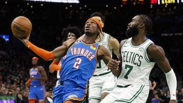 Shai Gilgeous-Alexander #2 of the Oklahoma City Thunder goes past Jaylen Brown #7 of the Boston Celtics